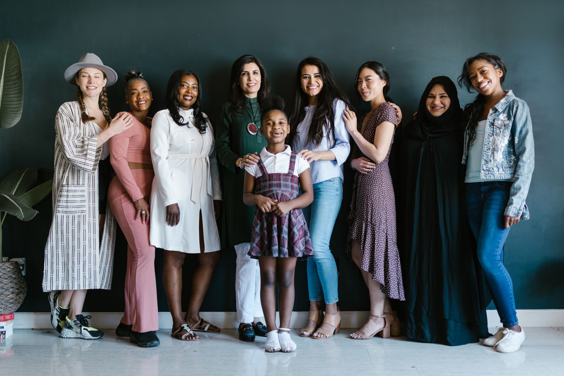A diverse group of mothers and children standing together